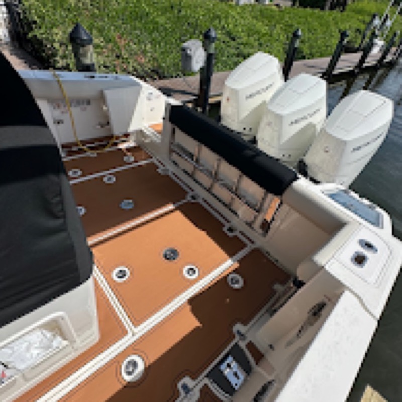 Triple outboards on the transom of a center console after a Dynasty Marine Customs install