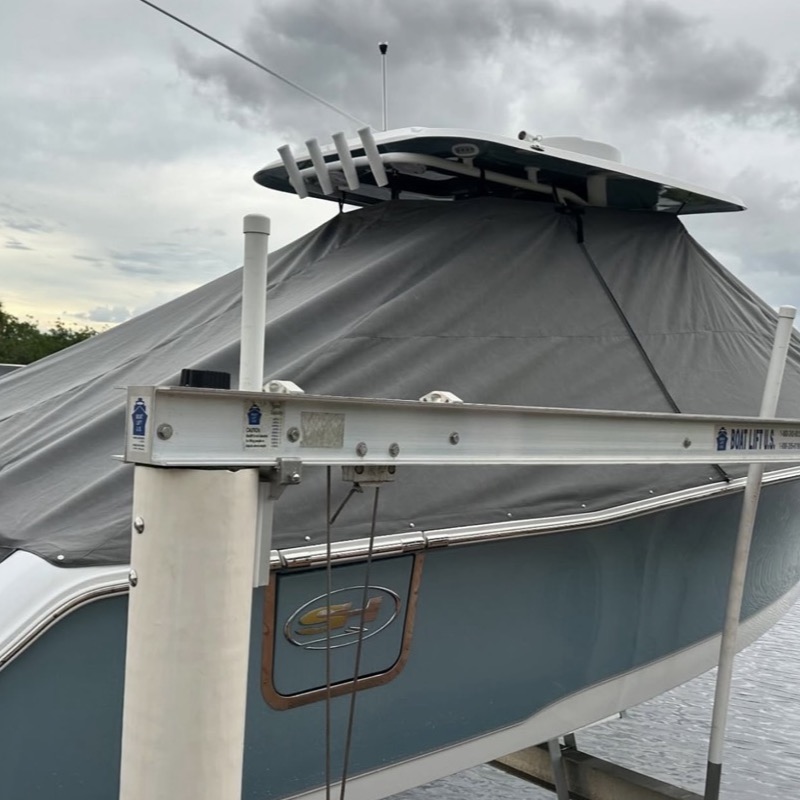 Custom canvas cover protecting a center console on a boat lift