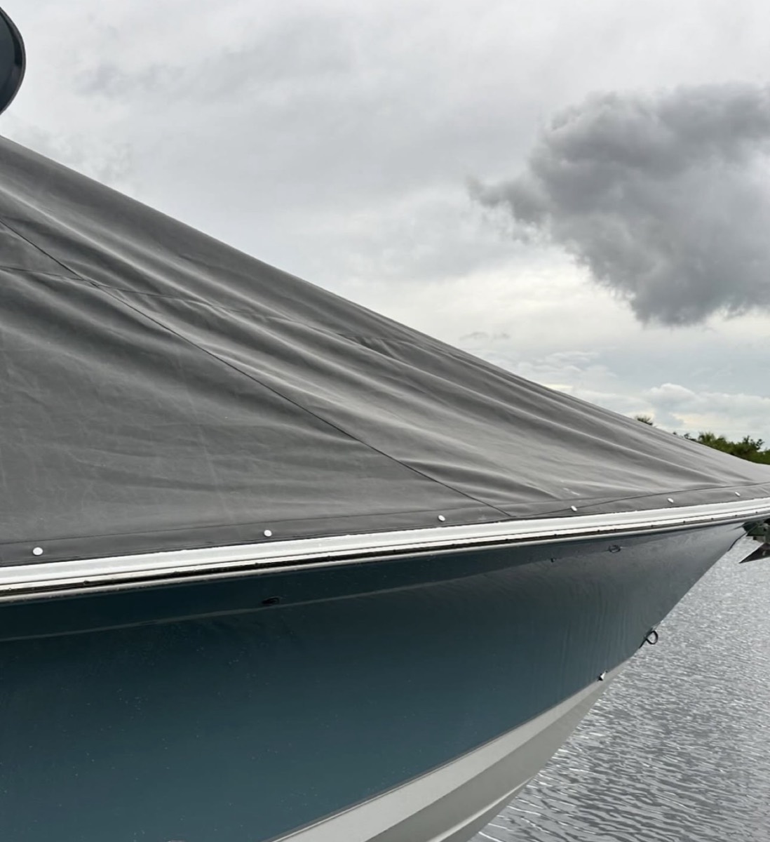 Custom-fitted canvas cover stretched over a center console, shown in profile