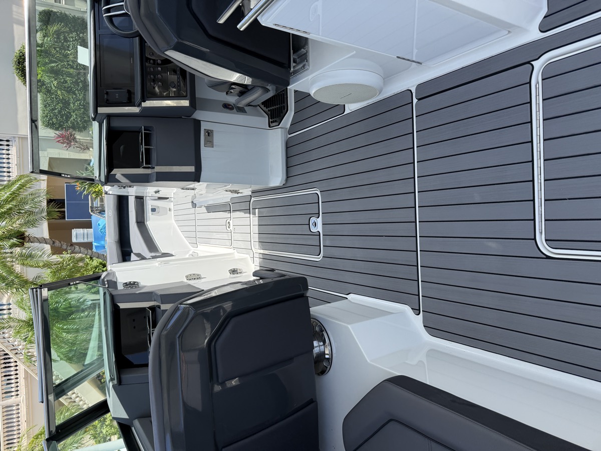 Grey teak-look marine decking through the cockpit and walkway of a sport cruiser