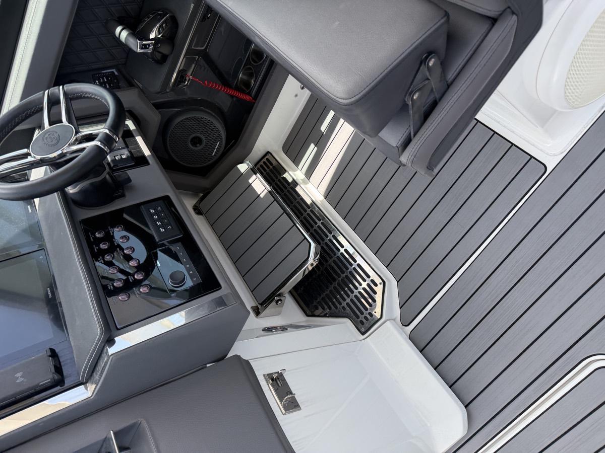 Custom decking fitted around the helm, step and footwell of a sport cruiser