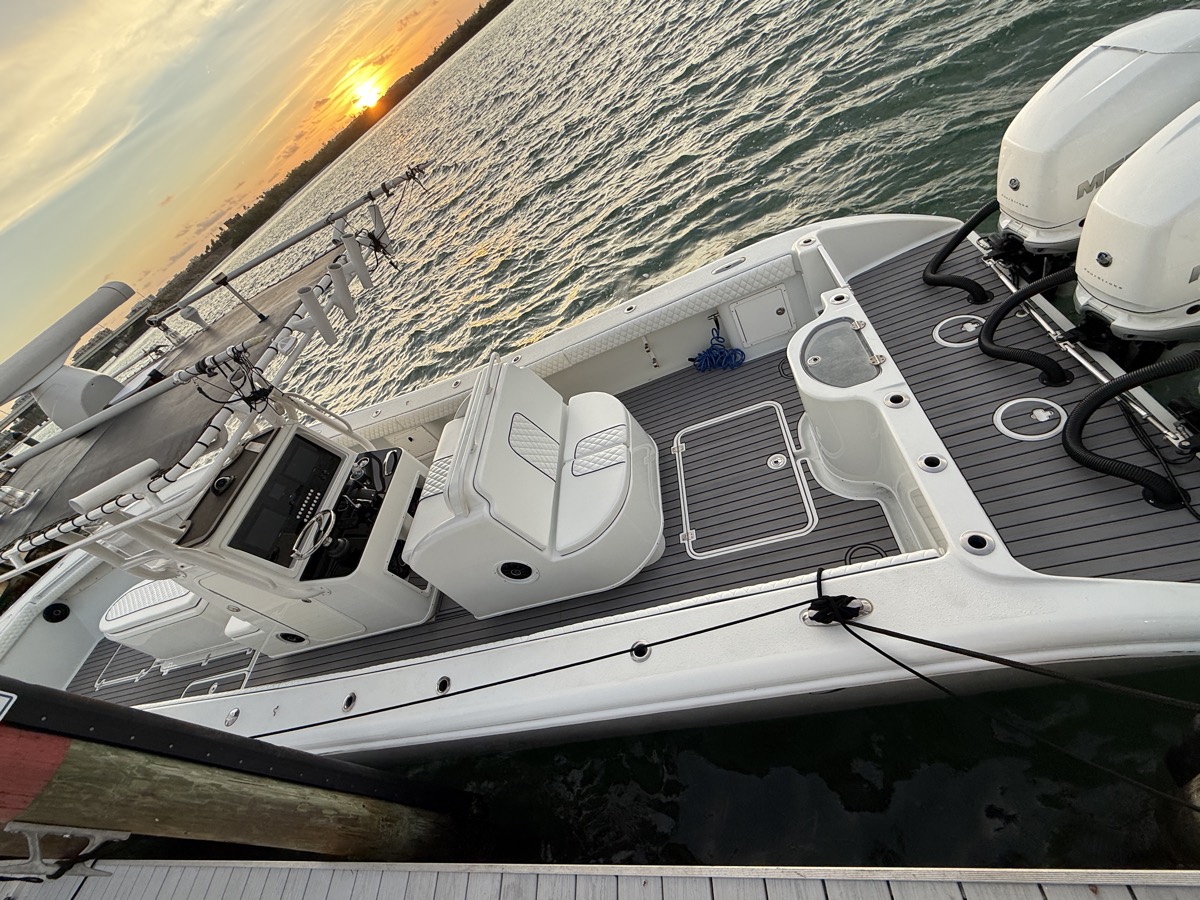 Center console with fresh marine decking tied up at sunset