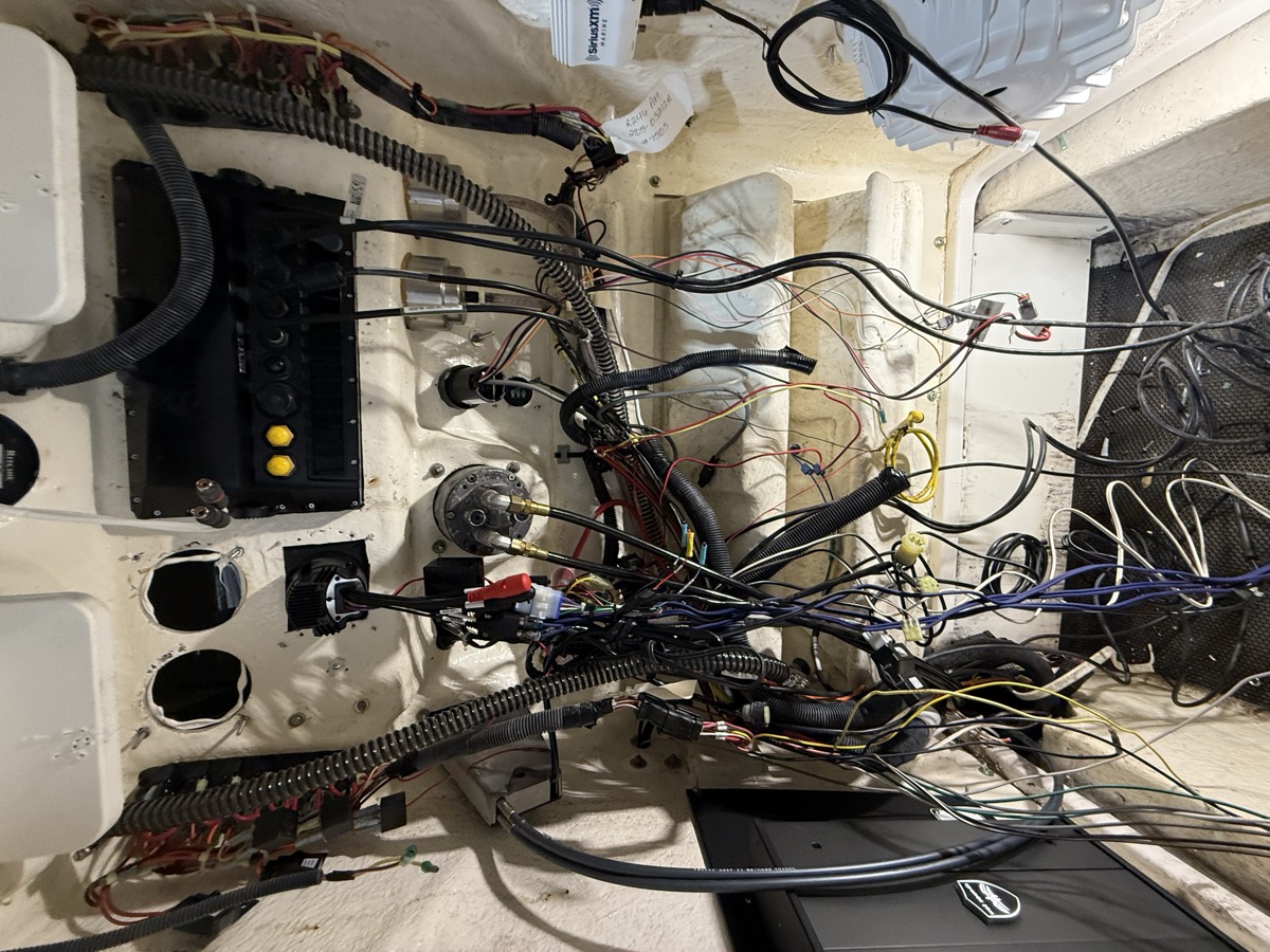 Before: tangled, unsupported wiring behind the helm of a center console