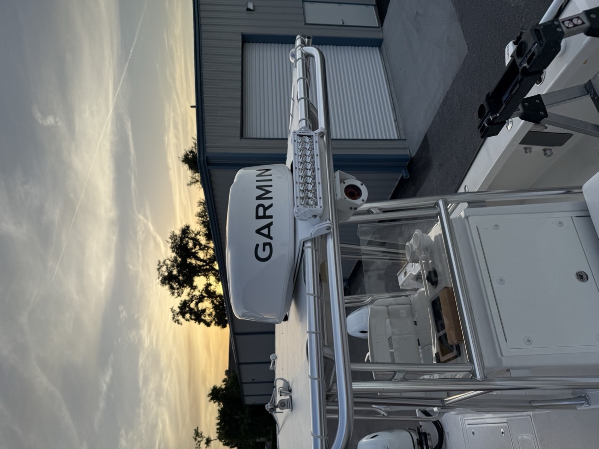 Garmin radar dome and spreader lights mounted on a hardtop tower at sunset