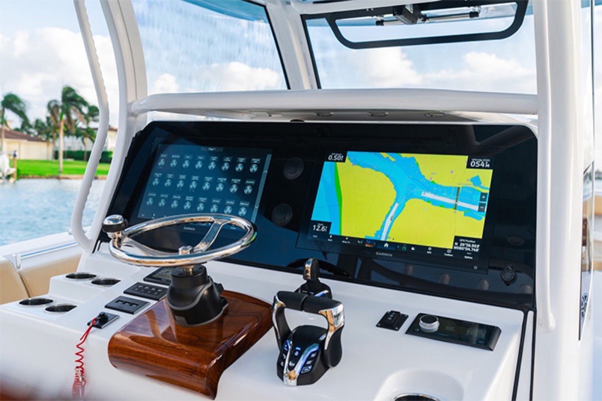 Finished center console helm with twin Garmin displays and chartplotter, installed by Dynasty Marine Customs
