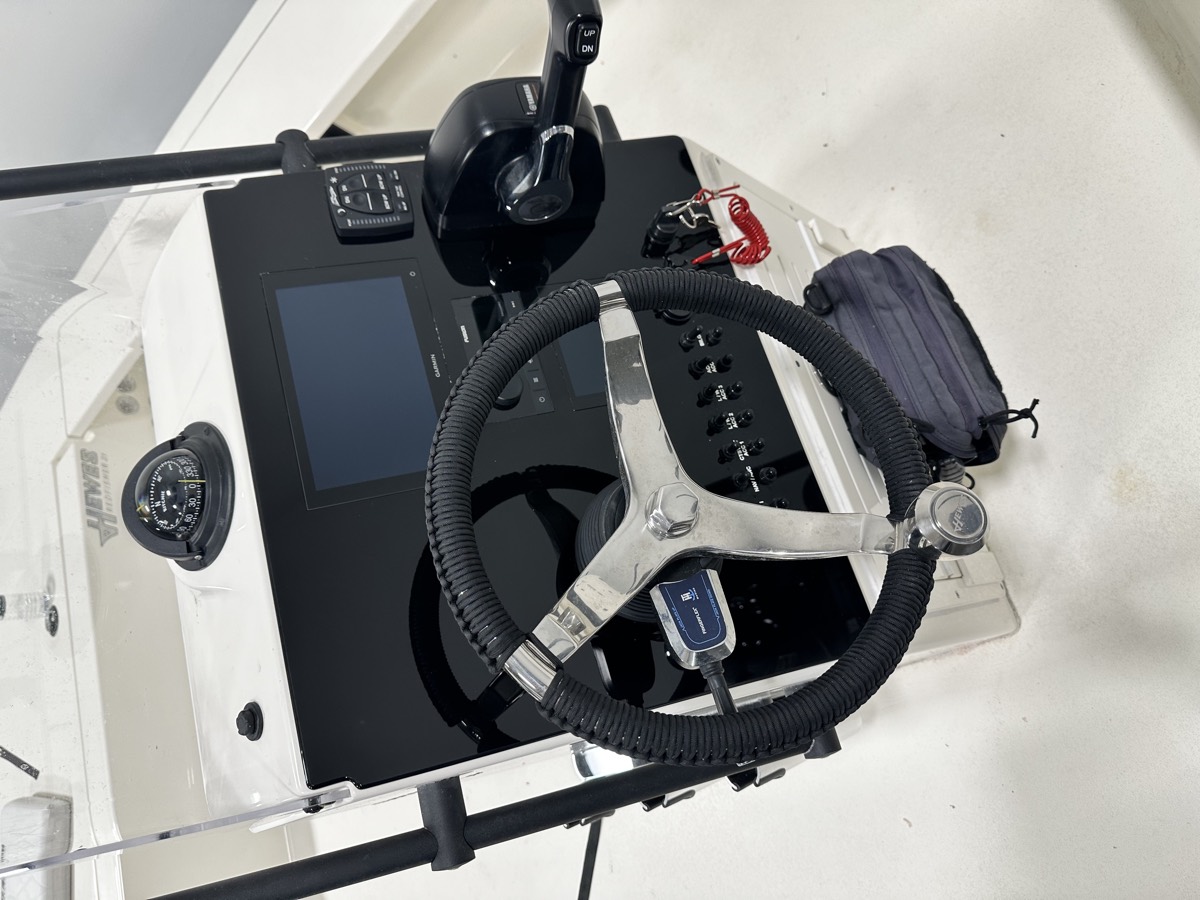 Custom acrylic dash on a bay boat with a flush-mounted chartplotter and compass