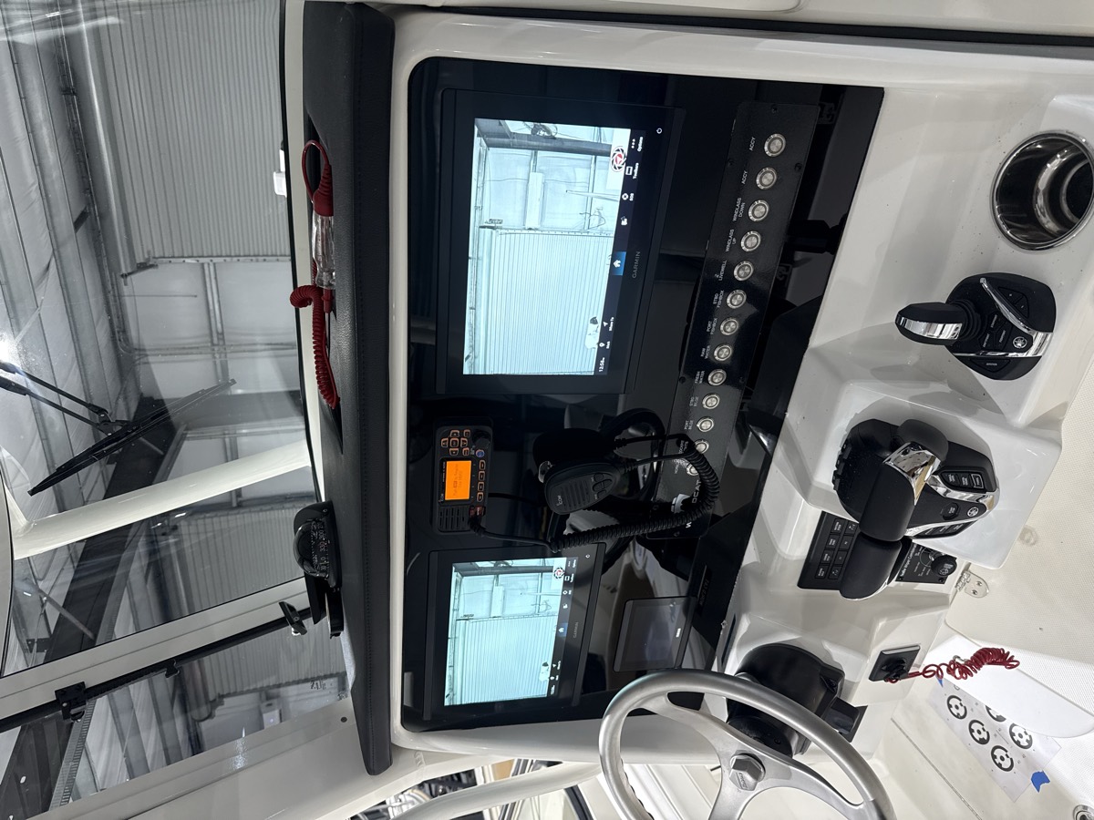 Custom dash panel with twin flush-mounted displays and a switch row on a center console