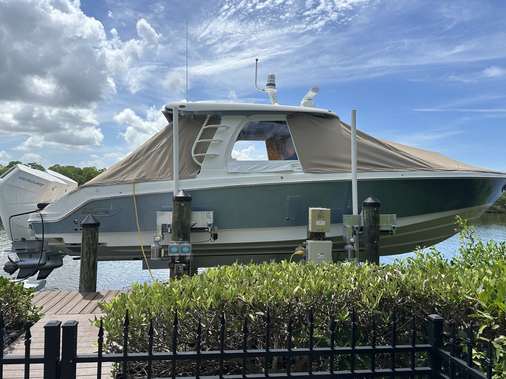 Custom canvas cover fitted over a center console T-top on a boat lift