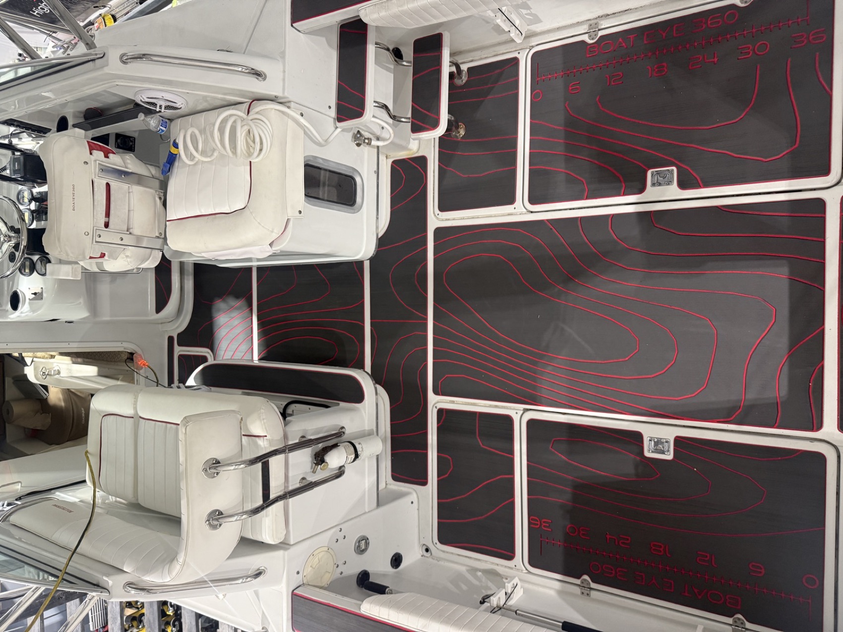 Full cockpit of custom marine decking with red topographic contour detail