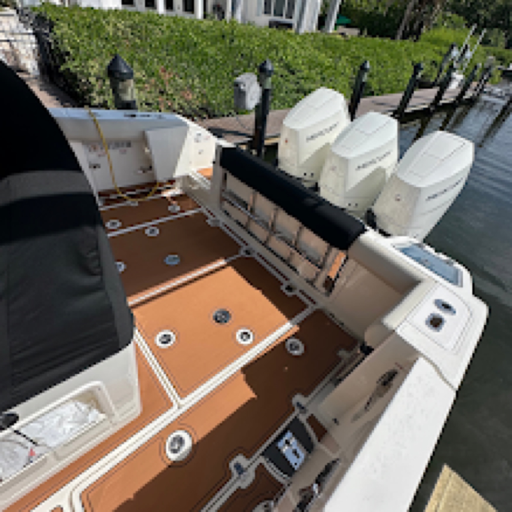 Row of outboard-powered boats inside the Dynasty Marine Customs shop in Sarasota