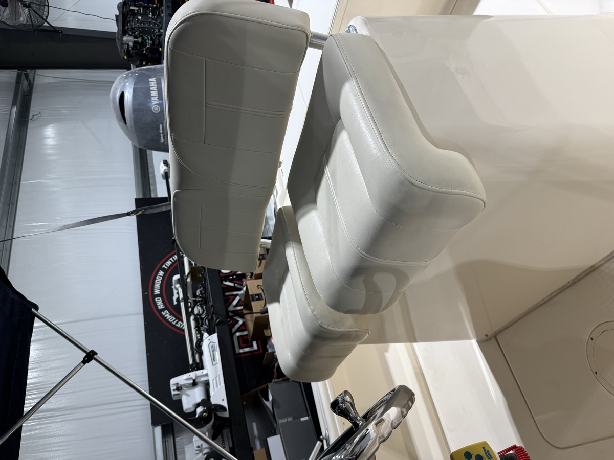 Rebuilt helm seat and backrest in marine-grade vinyl inside the Dynasty Marine Customs shop